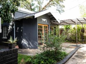 a house with a black facade at Leaf & Lark in Bloemfontein