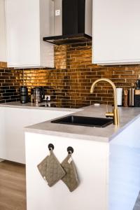 a kitchen with white cabinets and a sink and a sink at bijDorien in Gennep +130 photos