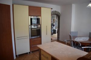 a kitchen with a refrigerator and a stove at Domček pod Kalváriou in Ružomberok