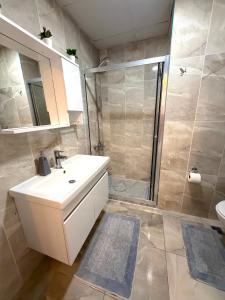 a bathroom with a white sink and a shower at King Suite BH37 in Istanbul +8 photos