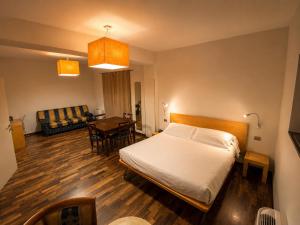 a bedroom with a bed and a living room at San Lorenzo Si Alberga in Camigliatello Silano