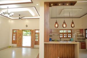 a kitchen with pendant lights and a kitchen island at NilaTheeram in Trivandrum
