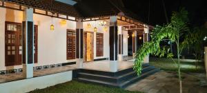 a house with a staircase leading to the front door at NilaTheeram in Trivandrum