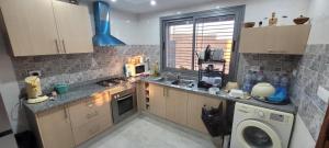 a kitchen with a sink and a washing machine at Villa in Ouled Yaneg in Ouled Yaneg