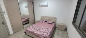 a small bedroom with a bed and a mirror at Villa in Ouled Yaneg in Ouled Yaneg
