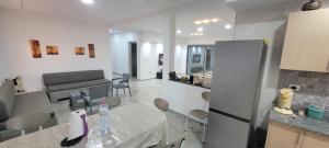 a kitchen and living room with a table and a piano at Villa in Ouled Yaneg in Ouled Yaneg