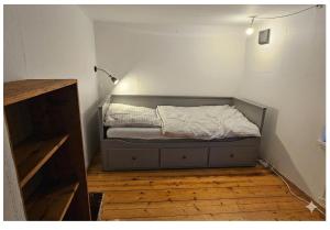 a small bedroom with a bed in the corner at Typisches Schwedisches Haus in Eriksmåla +5 photos