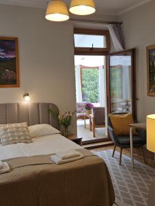 a bedroom with a bed and a living room at Willa Iskra in Zakopane