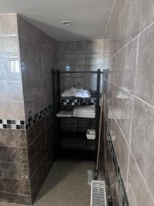 a bathroom with a walk in shower with bunk beds at Résidence Les Camélias in Tabarka +36 photos