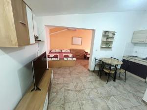 a small room with a bed and a table at Hostel Obrovac in Obrovac