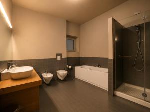 a bathroom with two toilets and a sink and a tub at San Lorenzo Si Alberga in Camigliatello Silano +69 photos