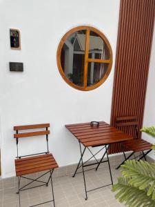 a table and two chairs and a mirror at แอดโฟร์รีสอร์ท in Ban Phrao