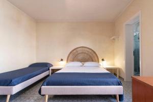 a bedroom with two beds and a window at Casa Baia smeraldo in Leuca
