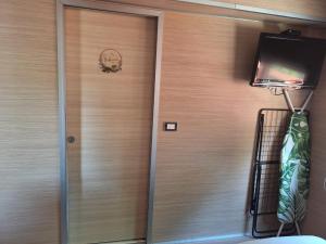 a door with a skull on it next to a television at Spacious Mobile Home "House Lena" for 7 in Eurocamp Rača - Sea View & Private terrace in Sveti Juraj