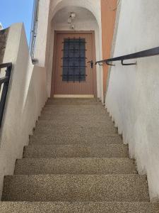 a set of stairs leading to a wooden door at Hostel Obrovac in Obrovac