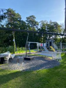 a park with a playground with a swing at Dom z Widokiem in Augustów