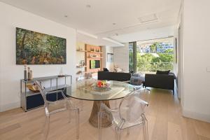 a living room with a glass table and chairs at Marina 107 in Cape Town
