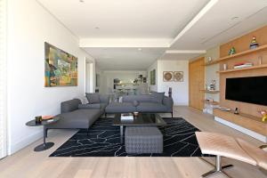 a living room with a couch and a tv at Marina 107 in Cape Town