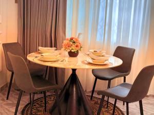 a table with chairs and plates and flowers on it at J-Ver Haven in Kasoa +4 photos