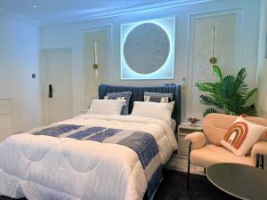 a bedroom with a large bed and a chair at J-Ver Haven in Kasoa