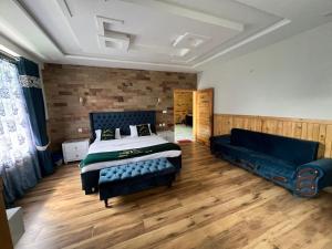 a bedroom with a bed and a couch in it at Pine Peaks Heaven in Nathia Gali +9 photos