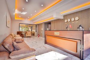 a living room with a couch and a table at Side Ertaş Otel in Side