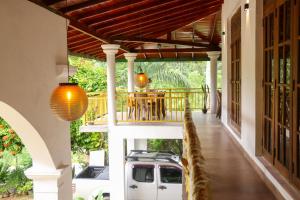 a porch of a house with a white truck parked on the porch at Benvilla Kandy in Kandy