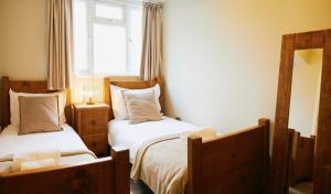 a bedroom with two beds and a window at Whitby Old Town Stay, Sleeps 4, The Nest in Whitby