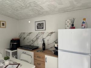 a kitchen with a white refrigerator and a table at Il BORGO in Lapedona +17 photos