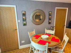 a dining room with a wooden table and chairs at Waterloo Cottage in Barnard Castle +13 photos