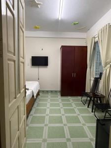 a room with a bedroom with a bed and a tv at An Bình Tài Hotel in Danang
