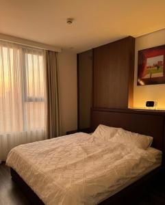 a bedroom with a large bed with a window at Anmie Home - Hoàng Huy CMC in An Khê