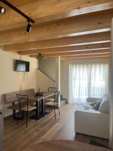 a living room with a table and a couch at Mirtillo in Tassullo