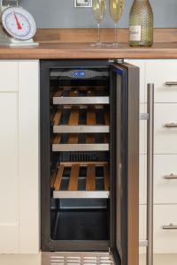 an open oven with wine bottles inside of it at Four Oaks Cottage in Rockcliffe