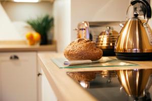 a loaf of bread on a plate on a kitchen counter at Whitby Old Town Stay, Sleeps 4, The Nest in Whitby