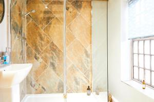 a bathroom with a shower and a sink at Whitby Old Town Stay, Sleeps 4, The Nest in Whitby