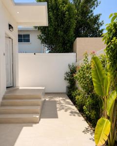 a courtyard of a house with stairs and plants at La Plage Bungalow in Dubai