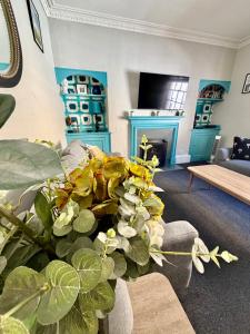 a living room with a plant in a vase at Dream Stays Bath - Trim Street Townhouse with Hot tub in Bath