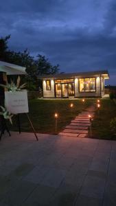 a building with a sign in front of it at night at Vino & Vista in Ripanj