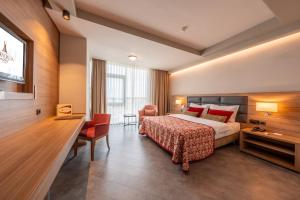 a hotel room with a bed and a desk at Grand Asya Hotel in Bandırma