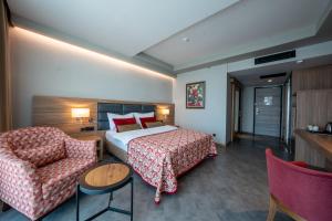 a hotel room with a bed and a couch at Grand Asya Hotel in Bandırma