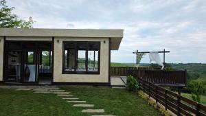 a house with a balcony with a view at Vino & Vista in Ripanj