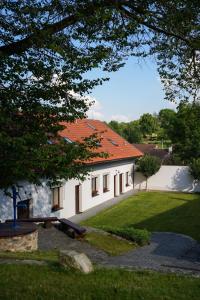 a white building with an orange roof at Statek Český Dvůr in Postupice
