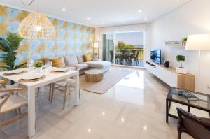a living room with a white table and a couch at AG Aiguablava Vista Mar in Playa de Gandia