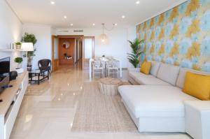 a living room with a white couch and a table at AG Aiguablava Vista Mar in Playa de Gandia
