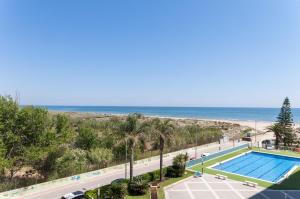 a view of a swimming pool and the beach at AG Aiguablava Vista Mar in Playa de Gandia