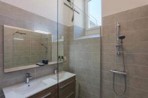 a bathroom with a shower and a sink and a mirror at T4 Cosy - Château - Wifi in Aubenas +17 photos