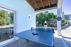 a ping pong table in the middle of a room at Villa Belchior by Algarve Holidays in Faro