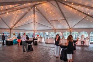 a group of people standing in a tent with tables at Chicago Marriott Suites Deerfield in Deerfield +75 photos