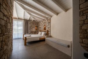 a bedroom with a bed and a brick wall at Moranka by ALS ALAÇATI in Alaçatı +51 photos